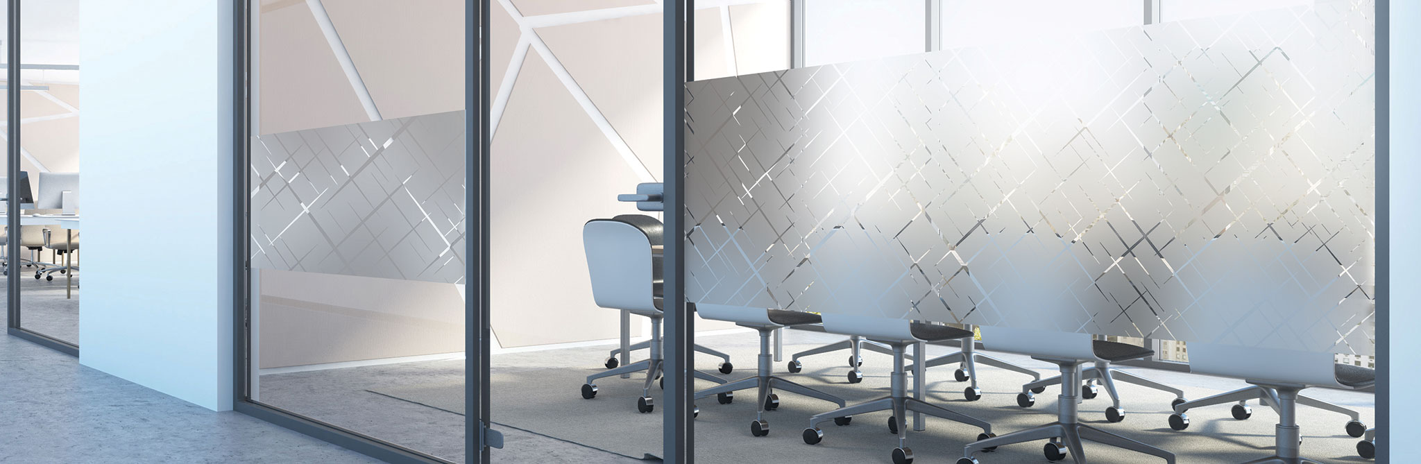 Office meeting room with glass walls covered in geometric frosted film patterns, with chairs and tables visible behind the semi‑opaque design. 